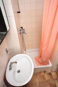 bagno con lavandino e doccia con tenda arancione di Apartment Palit 5061a a Rab
