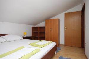 a bedroom with a bed and wooden cabinets at Apartment Gradac 6819a in Gradac