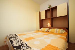 a bedroom with a large bed in a room at Apartment Starigrad 6587b in Starigrad-Paklenica