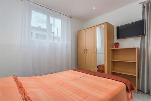 a bedroom with a bed and a tv and a window at Studio Novigrad 2536b in Novigrad Istria