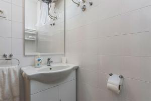 a white bathroom with a sink and a mirror at Studio Novigrad 2536b in Novigrad Istria