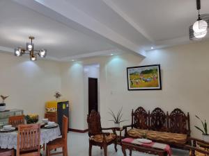a living room with a table and chairs at Simply Ur Home in Lucena in Lucena