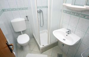 a bathroom with a toilet and a sink and a shower at Studio Drvenik Gornja vala 4890e in Drvenik