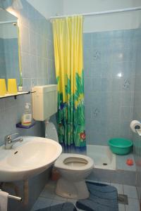 a bathroom with a sink and a toilet and a shower at Studio Tisno 5091a in Tisno