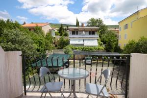 a balcony with a table and chairs and a pool at Studio Selce 5206e in Selce