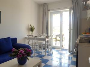 a living room with a blue couch and a table at Studio Banjol 5071a in Rab