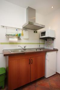 a kitchen with a sink and a microwave at Studio Gradac 6661a in Gradac