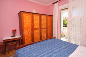 a bedroom with a bed and a large window at Double Room Palit 5061a in Rab