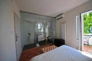 a bedroom with a glass walled shower and a bed at Double Room Banjol 5077a in Rab