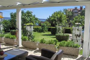 a patio with a view of a garden at Studio Selce 4801a in Selce