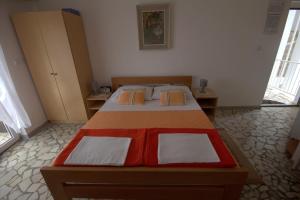 a bedroom with a large bed in a room at Studio Selce 4801a in Selce