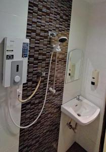 a bathroom with a shower and a sink at Dream House Hotel in Skudai