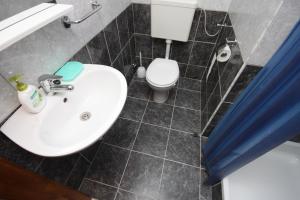 a bathroom with a white sink and a toilet at Double Room Gradac 6819a in Gradac