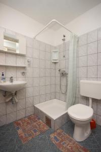 a bathroom with a toilet and a tub and a sink at Triple Room Sucuraj 6734c in Sućuraj