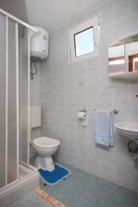 a bathroom with a toilet and a sink at Double Room Metajna 6496b in Metajna