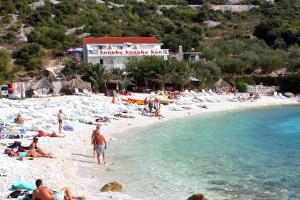 a group of people laying on a beach at Double Room Hvar 15378a in Hvar +15 photos