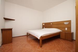 a small bedroom with a bed and a cabinet at Double Room Metajna 6487d in Metajna