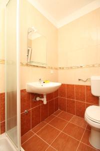 a bathroom with a sink and a toilet at Double Room Metajna 6487d in Metajna