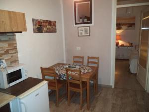 a kitchen and dining room with a table and chairs at La Casuzza in Castellammare del Golfo