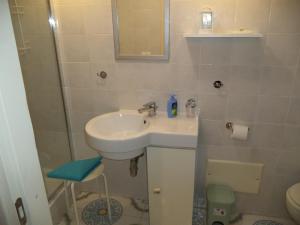 a small bathroom with a sink and a shower at La Casuzza in Castellammare del Golfo