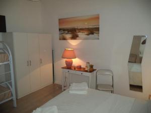 a bedroom with a bed and a table with a lamp at La Casuzza in Castellammare del Golfo