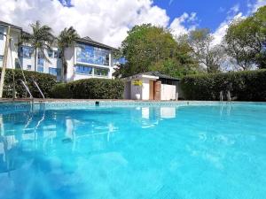 a large blue swimming pool in front of a house at New Safari Hotel 