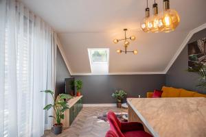 a living room with a table and some plants at Apartmány pod Zámkom in Bojnice