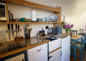 a kitchen with a counter top with a stove top oven at Culkein Pods in Lochinver