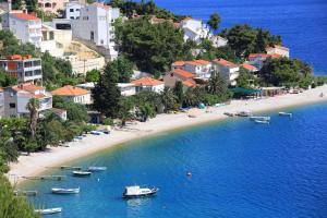 a view of a beach with boats in the water at Apartments with parking space Stanici, Omis - 10360 in Čelina
