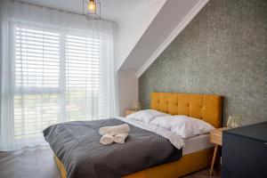 Postel nebo postele na pokoji v ubytování Apartmány pod Zámkom