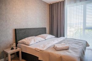 Postel nebo postele na pokoji v ubytování Apartmány pod Zámkom