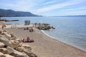 un gruppo di persone su una spiaggia vicino all'acqua di Apartments with WiFi Split - 13120 a Spalato (Split)