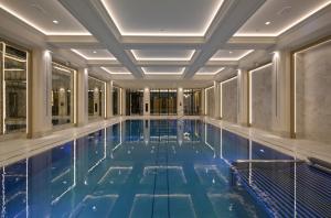a swimming pool in a building with a ceiling at Hotel Saski Krakow Curio Collection by Hilton in Krakow