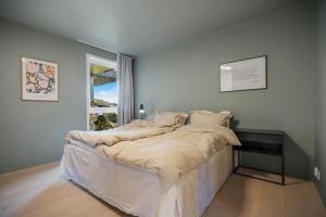 a bedroom with a bed in a room with a window at "Villa Bergen" 2min from beach & 10min from city centre in Bergen