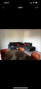a room with a table and chairs and a couch at Appartement spacieux, proche centre ville. in Ajaccio