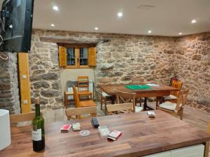 にあるCasa Rectoral de Montovo, casa rural en Red Natura 2000の石壁のダイニングルーム(テーブル付)