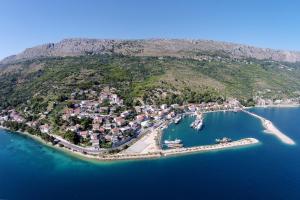 an aerial view of a small island in the water at Apartments by the sea Krilo Jesenice, Omis - 14459 in Jesenice