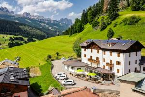 an aerial view of a building in a mountain at Ciasa Alpina Relax Hotel in Moena