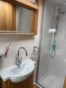 a bathroom with a sink and a shower at Inviting 4 Berth caravan in Hebden Bridge in Halifax