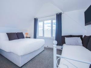 a bedroom with two beds and a window at OYO Pier Hotel in Clacton-on-Sea