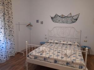 um quarto com uma cama branca e um edredão em I VACANZIERI em Avola