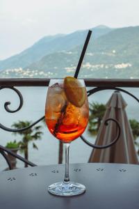 a drink sitting on a table on a balcony at Ca Meison in Cannobio