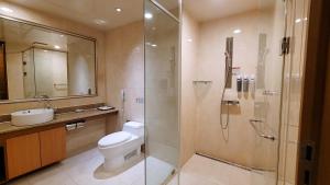 a bathroom with a shower and a toilet and a sink at Ramada Hotel and Suites Seoul Namdaemun in Seoul
