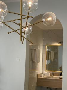 a bathroom with a chandelier in front of a mirror at MK Resort in Doha