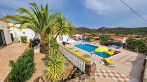 an overhead view of a swimming pool with palm trees at Casa Branca Holiday Resort in Salir