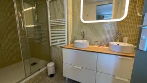 une salle de bain avec deux lavabos et une douche dans l'établissement Au cœur du vieux Toulon au calme appartement rénové climatisé confortable étage élevé avec ascenseur proche parking et toutes commodités, à Toulon