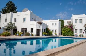 a villa with a swimming pool in front of a building at Seckin Konaklar in Bodrum City