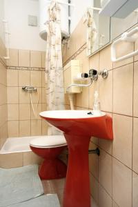 a bathroom with a red sink and a toilet at Apartments by the sea Sucuraj, Hvar - 6732 in Sućuraj +44 photos