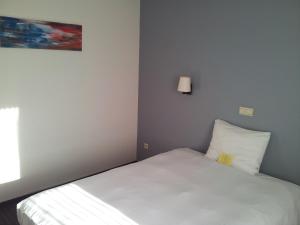 Postel nebo postele na pokoji v ubytování Hotel De Swaen
