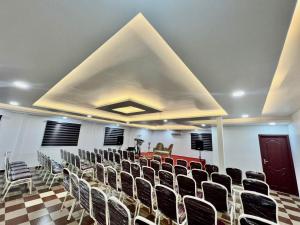 a conference room with chairs and a large ceiling at NIDHI RESIDENCY in Guruvāyūr